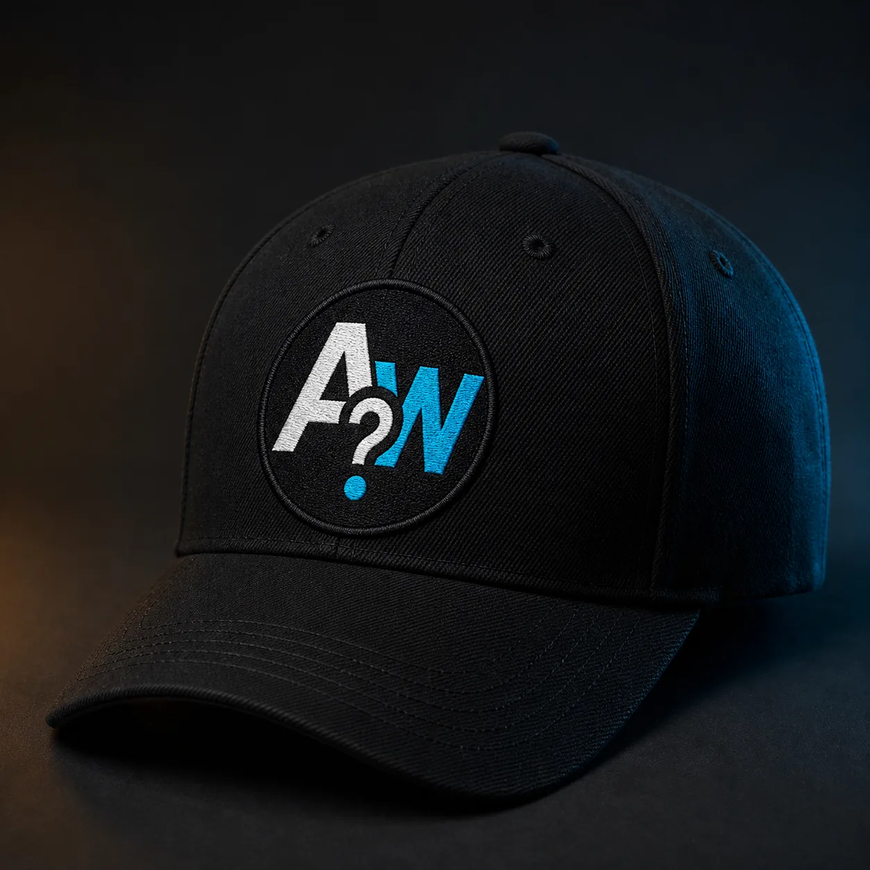 Black Ask Why Guys cap with an embroidered round AW question-mark logo patch